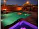 Backyard pool area with a spa, fire bowls, and ambient lighting for evening enjoyment at 7630 Canyon Diablo Rd, Las Vegas, NV 89179