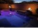 Inviting pool area featuring a fire feature, waterfall features, and a brick surround, perfect for outdoor entertaining at 7630 Canyon Diablo Rd, Las Vegas, NV 89179
