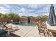 Outdoor pool area with a bar, seating, and desert landscaping at 7630 Canyon Diablo Rd, Las Vegas, NV 89179