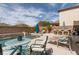 Relaxing pool area with patio seating, perfect for enjoying sunny days outdoors with waterfall feature at 7630 Canyon Diablo Rd, Las Vegas, NV 89179