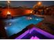 Stunning pool area with a spa, fire bowls, and ambient lighting for evening enjoyment at 7630 Canyon Diablo Rd, Las Vegas, NV 89179
