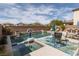 Inviting pool area featuring a basketball hoop, lounge chairs, and manicured landscaping, perfect for outdoor relaxation at 7630 Canyon Diablo Rd, Las Vegas, NV 89179