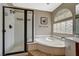 Bright bathroom with shower, tub, a unique window, and neutral wall color at 7637 Good Fortune Ct, Las Vegas, NV 89139