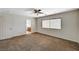 Bedroom with neutral paint, carpet, a fan, a window, and an ensuite at 7637 Good Fortune Ct, Las Vegas, NV 89139
