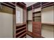 Walk-in closet with wood-finished shelving and cabinets for organization at 7637 Good Fortune Ct, Las Vegas, NV 89139