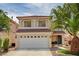 Charming two-story home showcasing a well-maintained lawn and attached two-car garage at 7637 Good Fortune Ct, Las Vegas, NV 89139
