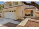 Inviting home exterior featuring a two-car garage, cozy porch, and manicured landscaping at 7637 Good Fortune Ct, Las Vegas, NV 89139