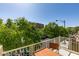 Cozy balcony area with a brown wooden table and railing offers a scenic view of the neighborhood at 7645 Interlace St, Las Vegas, NV 89149
