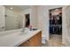Bright bathroom showcasing a vanity with storage, a toilet, and an open closet for added convenience at 7645 Interlace St, Las Vegas, NV 89149