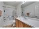 Clean bathroom showcasing a tub, a toilet, and a vanity with a mirror at 7645 Interlace St, Las Vegas, NV 89149