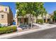 Street view of house featuring a covered porch, lush tree, and private drive at 7645 Interlace St, Las Vegas, NV 89149