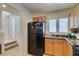 Functional kitchen with granite countertops, black appliances, and ample cabinet space, offering style and practicality at 7645 Interlace St, Las Vegas, NV 89149