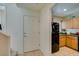 Cozy kitchen that leads to carpeted stairwell and dining area at 7645 Interlace St, Las Vegas, NV 89149