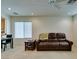 Cozy living room with neutral carpet, recessed lighting, and a comfortable leather sofa at 7645 Interlace St, Las Vegas, NV 89149