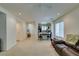 Bright and airy living room with neutral carpet, flowing into an open kitchen and dining area at 7645 Interlace St, Las Vegas, NV 89149