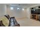 Comfortable living room with a brown leather sofa and neutral carpet and light-filled interior at 7645 Interlace St, Las Vegas, NV 89149