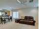 Bright living room area with neutral carpet, recessed lights, ceiling fan, and leather sofa at 7645 Interlace St, Las Vegas, NV 89149