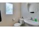 Well-lit powder room with modern fixtures, offering a clean and functional space for guests with a pedestal sink at 7645 Interlace St, Las Vegas, NV 89149