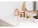 Stylish bathroom features a sleek vanity with a modern gold faucet and elegant decorative accents at 7825 Desert Bell Ave, Las Vegas, NV 89128