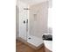 Modern bathroom showcases a glass shower, a white marble tile and a wooden floor at 7825 Desert Bell Ave, Las Vegas, NV 89128