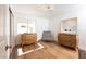 Bright bedroom with wood floors, and natural light from the window at 7825 Desert Bell Ave, Las Vegas, NV 89128