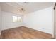 Bright, empty bedroom with wood floors and a ceiling fan offers a versatile space for personalization at 7825 Desert Bell Ave, Las Vegas, NV 89128