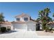 Charming two-story home with a three-car garage and well-manicured landscaping at 7825 Desert Bell Ave, Las Vegas, NV 89128