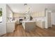 Modern kitchen featuring a large island, wooden floors, stainless steel appliances, and neutral toned cabinetry at 7825 Desert Bell Ave, Las Vegas, NV 89128