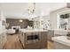 Kitchen with open floor plan, stainless microwave in island, and views into living room at 7825 Desert Bell Ave, Las Vegas, NV 89128
