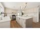 Neutral kitchen with modern island with seating, stainless appliances, and bright lighting at 7825 Desert Bell Ave, Las Vegas, NV 89128