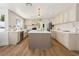 Bright kitchen featuring a large island, wooden floors, stainless steel appliances, and ample counter space at 7825 Desert Bell Ave, Las Vegas, NV 89128