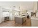 Bright open kitchen with wine fridge in island, stainless appliances, light colored cabinetry, and modern lighting at 7825 Desert Bell Ave, Las Vegas, NV 89128