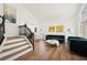 Cozy living room with staircase and view of lush garden at 7825 Desert Bell Ave, Las Vegas, NV 89128