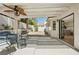 Inviting outdoor patio with a ceiling fan, comfortable seating, and desert landscaping at 7825 Desert Bell Ave, Las Vegas, NV 89128