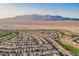 Expansive aerial view of a desert community near mountains and a golf course at 7957 Fantail Dr, North Las Vegas, NV 89084