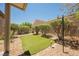 Turf grass area, decorative rocks, and shrubs are showcased in the backyard at 7957 Fantail Dr, North Las Vegas, NV 89084