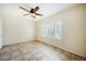 Comfortable bedroom with ceiling fan, tile flooring, and plantation shutters at 7957 Fantail Dr, North Las Vegas, NV 89084