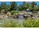 Picturesque pond with rocky waterfall and vibrant aquatic plants in a community setting at 7957 Fantail Dr, North Las Vegas, NV 89084