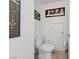 Bathroom featuring a modern toilet, tile floors, and tasteful artwork at 823 Schooner Dr, Henderson, NV 89015