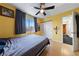 Comfortable bedroom with ceiling fan, wood floors and natural light from the window at 823 Schooner Dr, Henderson, NV 89015