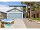 Two-story home featuring a gray garage door and desert landscaping, including inset of backyard pool at 823 Schooner Dr, Henderson, NV 89015