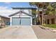 Charming two-story home featuring a well-maintained front yard and attached two-car garage at 823 Schooner Dr, Henderson, NV 89015