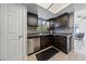 Kitchen with stainless steel dishwasher, mosaic backsplash, and plenty of cabinets at 823 Schooner Dr, Henderson, NV 89015