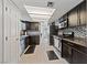 A well-lit kitchen with stainless steel appliances, dark wood cabinets, and tile backsplash at 823 Schooner Dr, Henderson, NV 89015