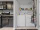 Functional laundry area featuring a stacked washer and dryer, with overhead shelving and ample storage at 823 Schooner Dr, Henderson, NV 89015