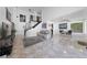 Open living room featuring a staircase, large windows, and neutral decor at 823 Schooner Dr, Henderson, NV 89015