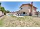 Expansive backyard featuring a private pool, patio area with furniture, and mature landscaping at 864 E Eldorado Ln, Las Vegas, NV 89123