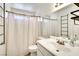 Cozy bathroom with a shower-tub combo, white vanity, and plenty of natural light at 864 E Eldorado Ln, Las Vegas, NV 89123