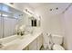 Bright bathroom with double vanity, large mirror, and toilet at 864 E Eldorado Ln, Las Vegas, NV 89123