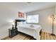 This bedroom features a comfortable queen-size bed, modern lamp, and stylish wood-look flooring at 864 E Eldorado Ln, Las Vegas, NV 89123
